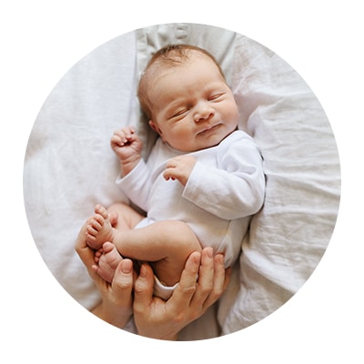 Newborn icon of a baby being cradled