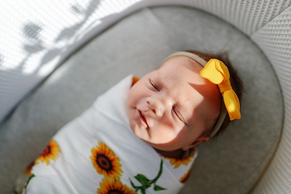 Baby asleep in bassinet - Perth Photographer review