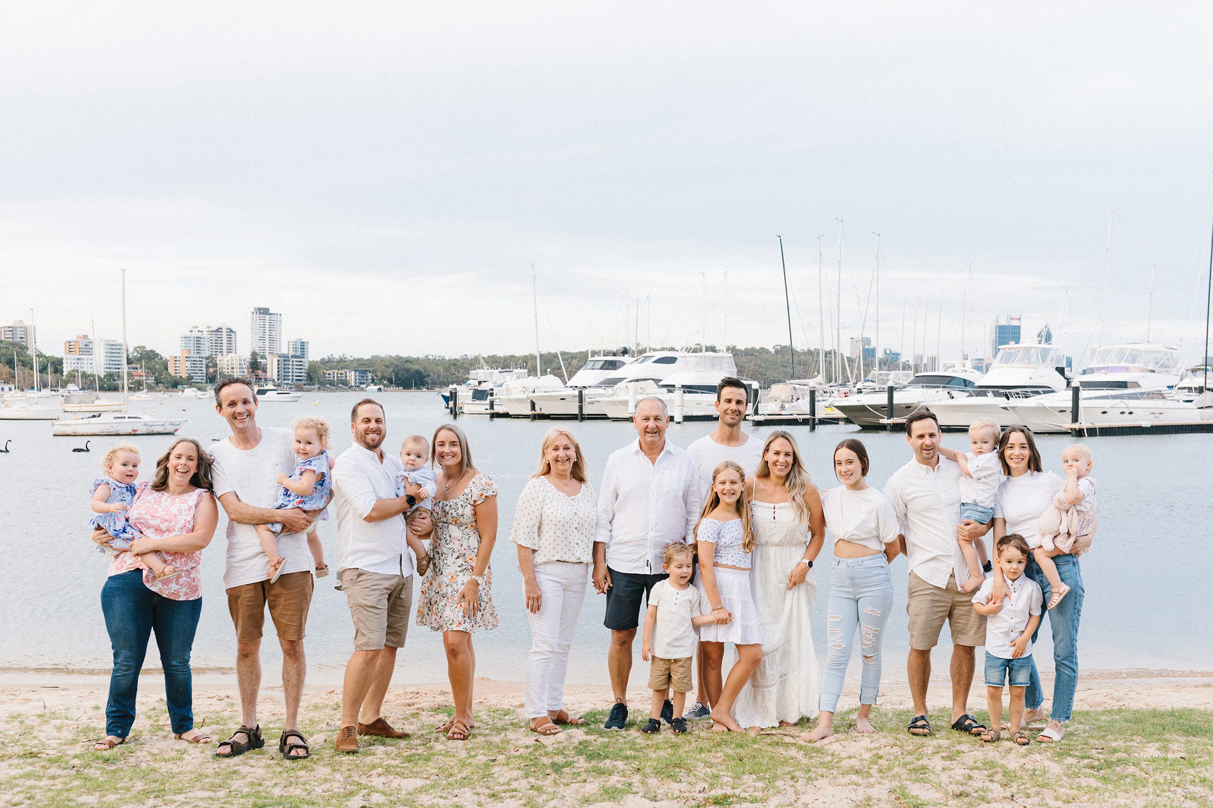 Extended family of 19 gathered by a riverside in Perth during a holiday photo session
