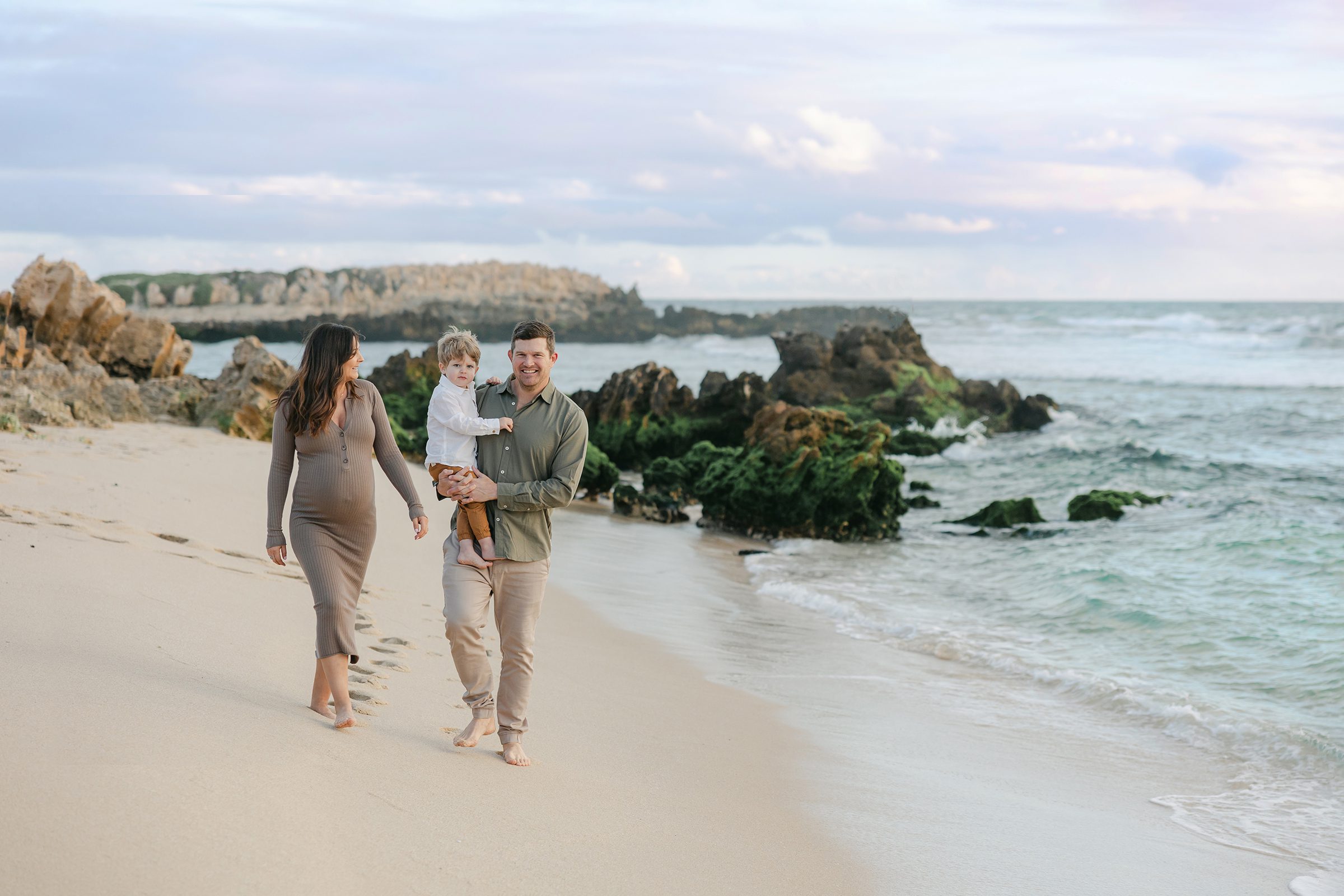 Expecting parents share a tender moment at Trigg Beach during their partner-inclusive maternity session with Perth photographer Jessica Lockhart