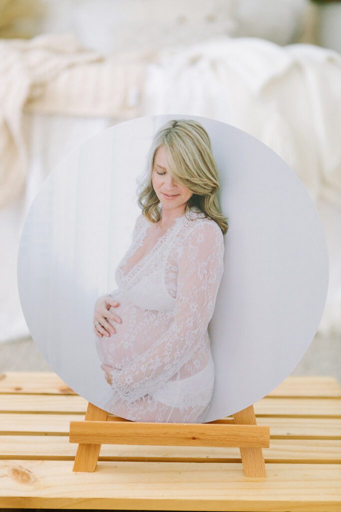 Small tabletop photo frame with maternity portrait, styled on a nightstand.