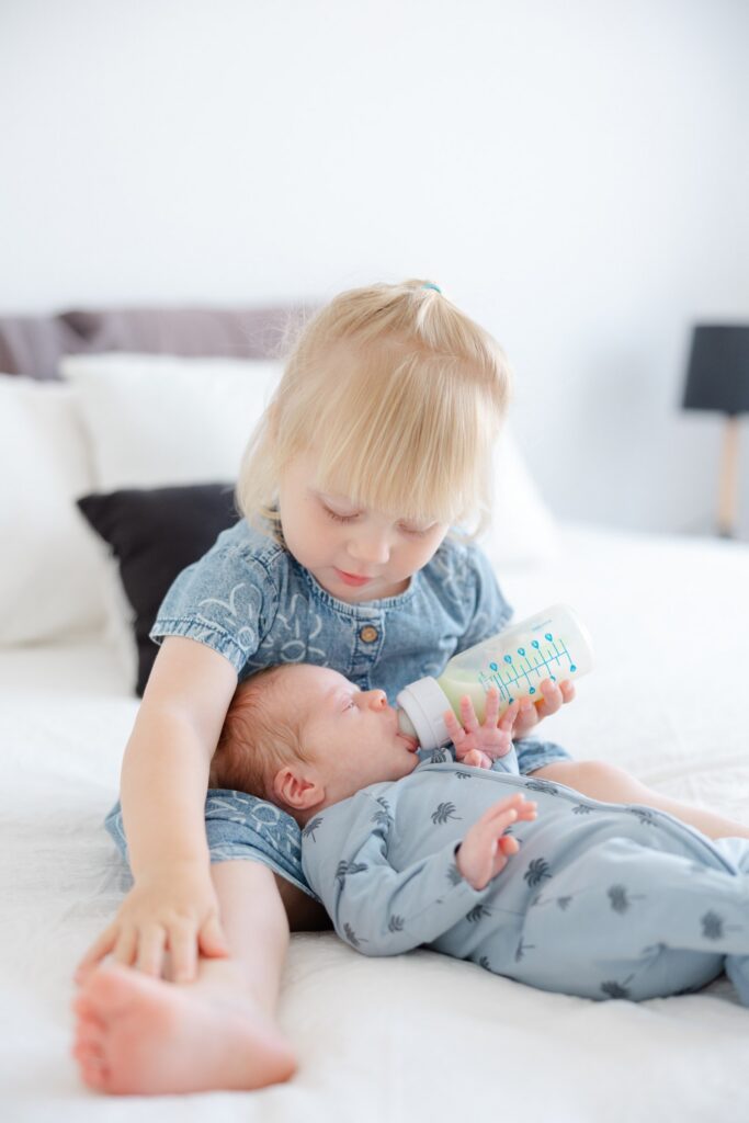 Toddler sibling with newborn baby during Perth family newborn photography session