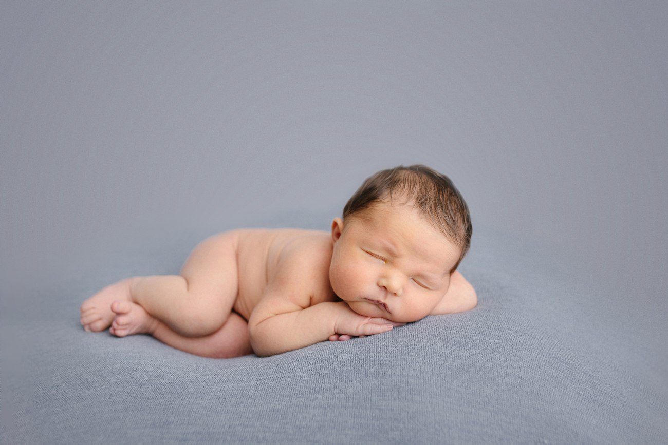 leeping newborn in scrunched pose during Perth studio newborn photography session
