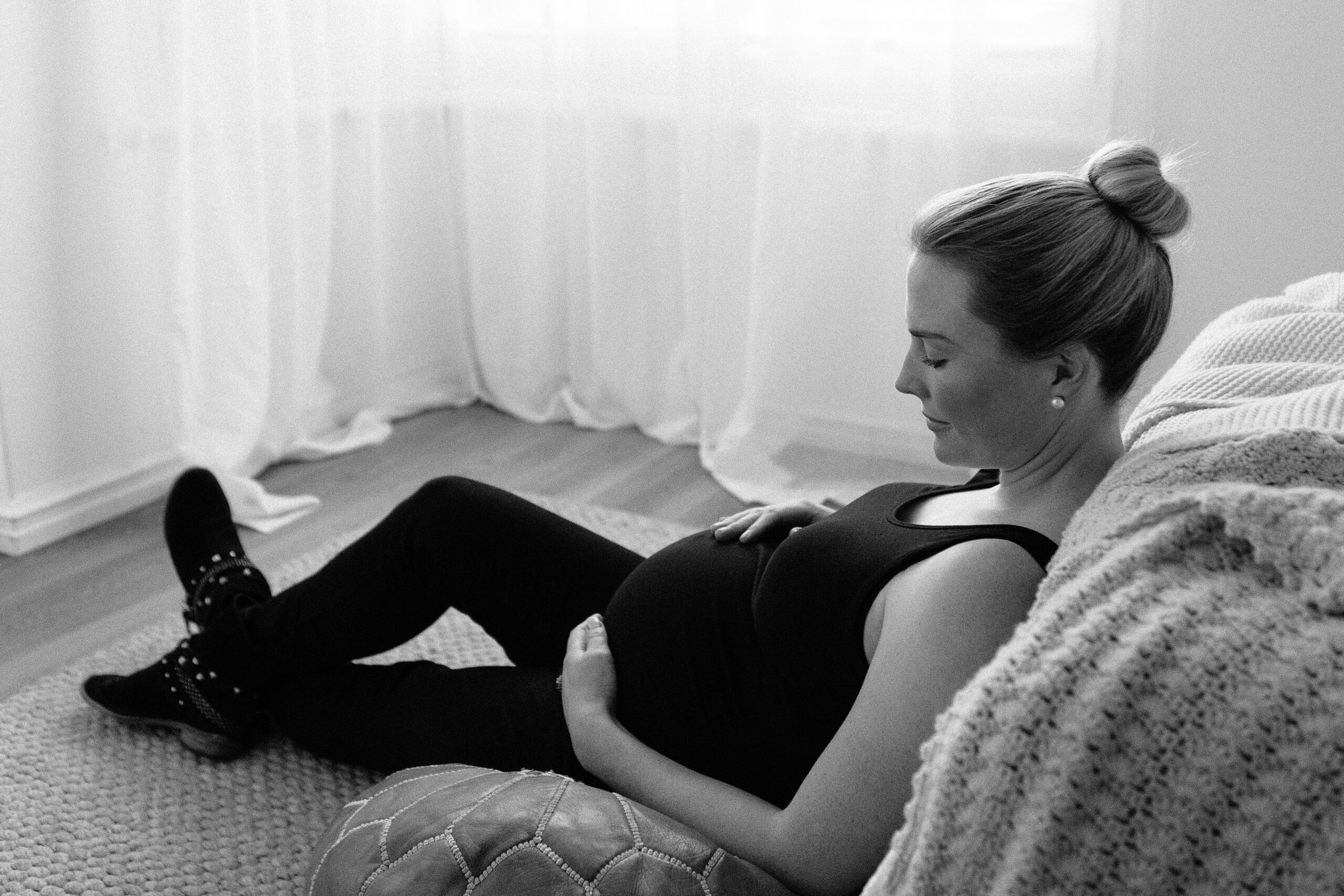 Perth maternity photographer guiding a home session, warm and relaxed atmosphere.